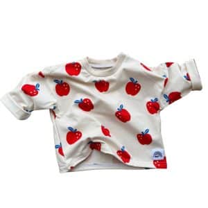 T-shirt bébé manches longues Pomme en coton bio sur fond crème